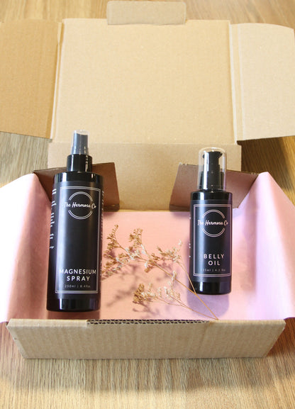 Two black bottles with a dropper on a wooden surface
